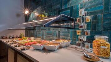 A buffet with various food items and condiments.