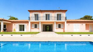 A two-story building with a swimming pool in front. - Modern Villa in a Quiet Location, 10' from the Center (Antibes)