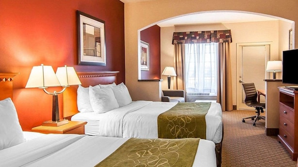 A hotel room with two beds, a desk, a chair, a TV, and a window with curtains. - City Express by Marriott Redmond Airport (REDMOND)