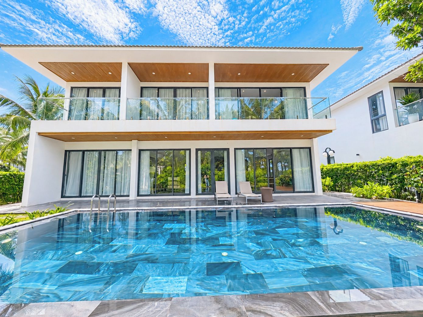 A modern two-story house with a swimming pool.