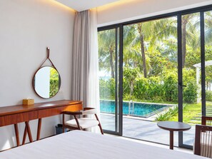 A hotel room with a large window, a bed, a desk, a chair, and a small table. - Sonasea Villas Collection Long Beach Phu Quoc (Phu Quoc)