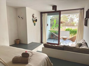 A bedroom with a bed, a window, a balcony, and a view of the outdoors. - Kasa Koh  (Brisas de Zicatela)