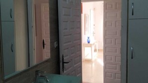 A bathroom with a sink, mirror, and cabinets.