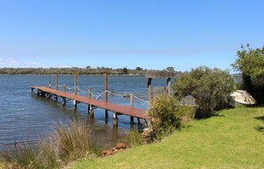 A wooden pier extending into calm water, surrounded by grassy areas and a sign reading "MAGARTHUR". - Riverscape Cottage No.11 - Riverscape - unit 11 with views over the Blackwood River and fire place (Augusta)
