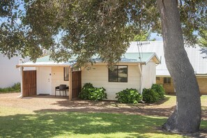 A small, single-story building with a door and a window, surrounded by a grassy area and a tree. - Riverscape Cottage No.4 - Riverscape Cottage No.4 is an easy walk to the Blackwood River (Augusta)