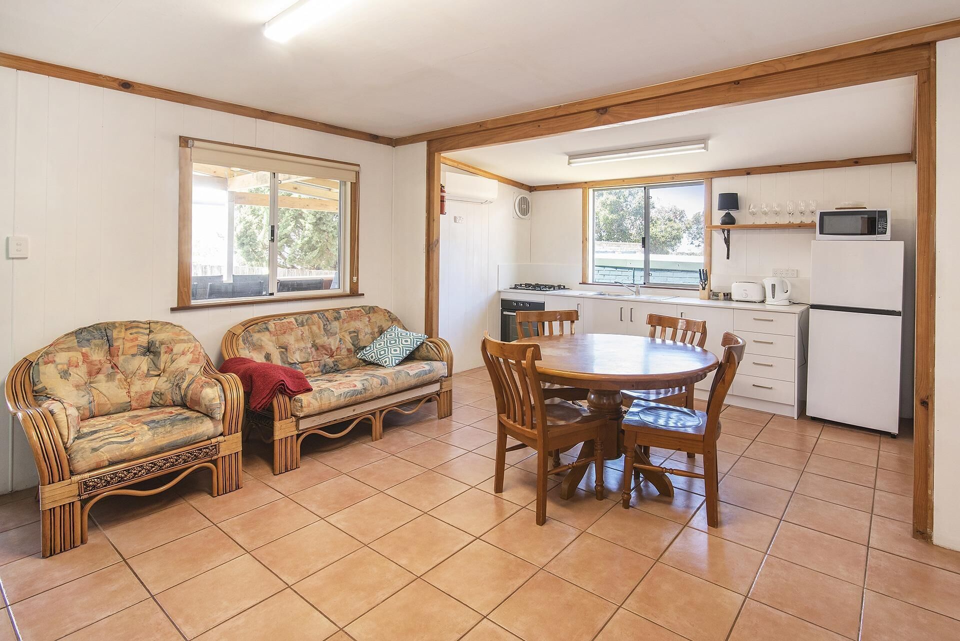Una habitación acogedora con sofá, mesa de comedor y zona de cocina.