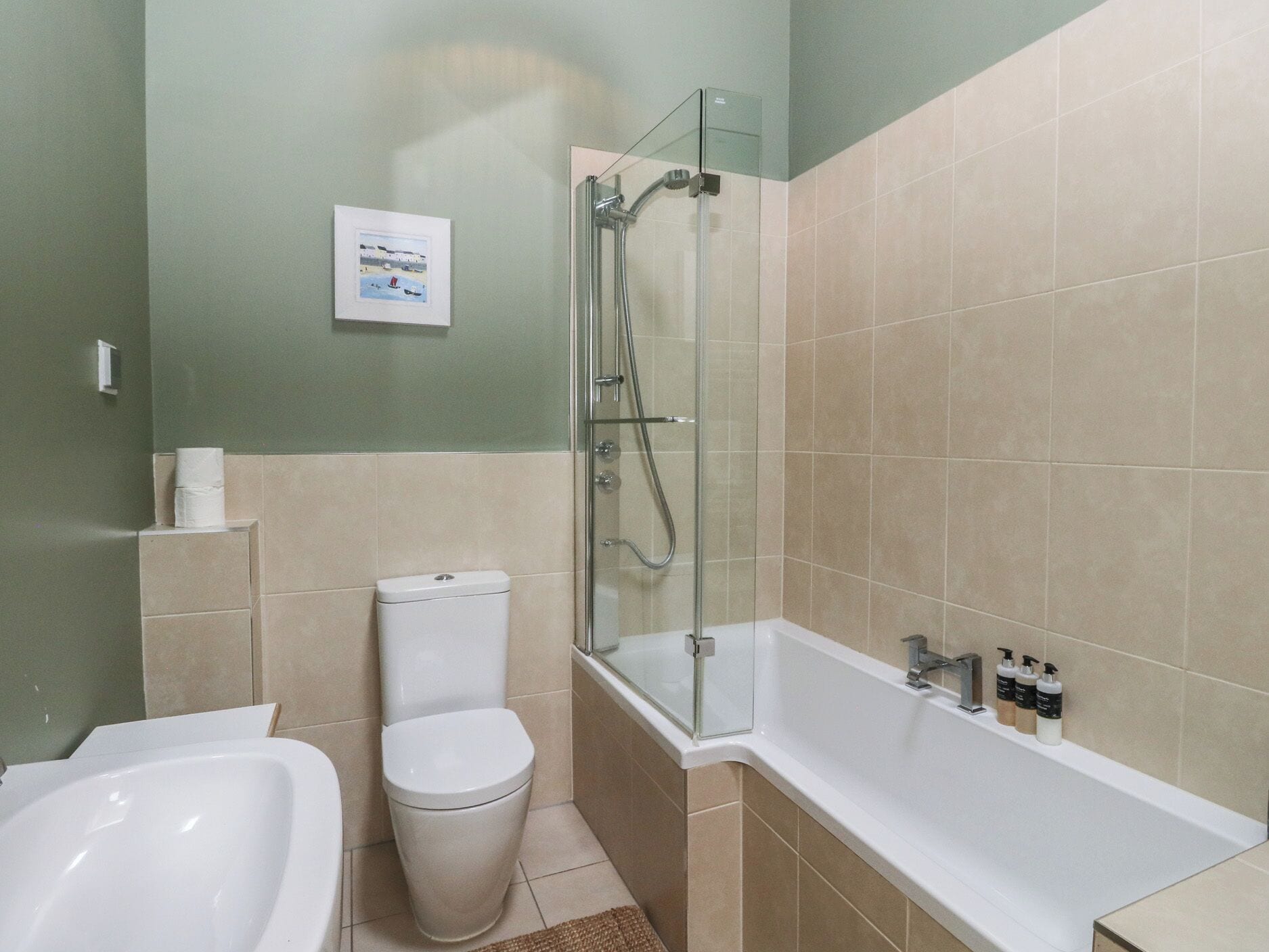 A bathroom with a toilet, a shower enclosure, and a bathtub.