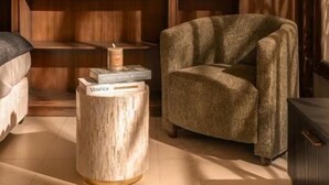 A room with a sofa, a round wooden side table, and a bookshelf. - Super lovely Villa in Phu My Hung by Ray (Ho Chi Minh City)