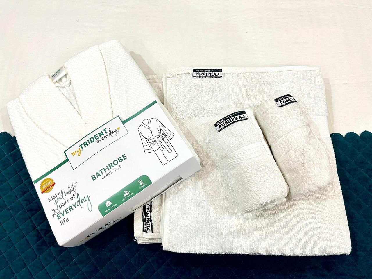 A box of MyTrident Everyday Bathrobe Large Size and two folded bathrobes with 'PUSHPAJ' tags.