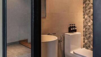 A bathroom with a toilet, a sink, and a shower.