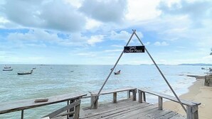 A wooden pier with a sign reading 'GAO Sator Mezz.' Boats are visible on the water.