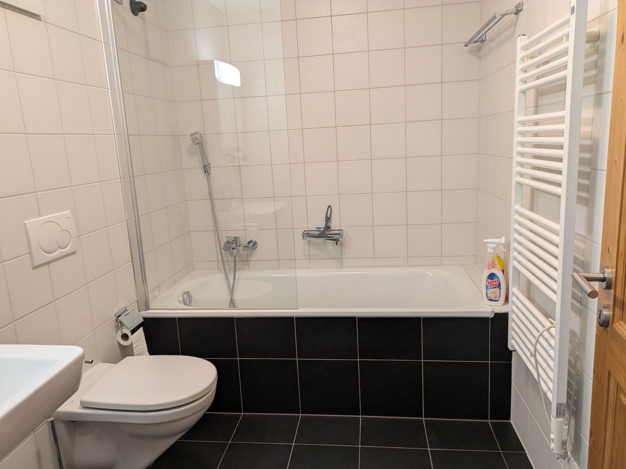 A bathroom with a bathtub, toilet, and a shower.