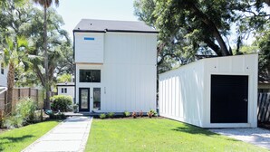 A two-story house with a garage, a front door, and a mailbox. - Fall Special! Newly updated large home with pool! (St Simons Island)