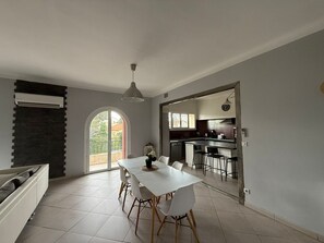 A modern kitchen with a dining area, a large window, and a view of the outdoors. - 4-Bedroom Apartment, 130 m², for Rehabilitation/Vacation Use (Balaruc-le-Vieux)