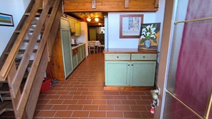 A staircase leading to a lofted area with a kitchen and dining area. - Chalet in Maremma with Private Pool and Wi-Fi, Apt 23 (Castel del Piano)