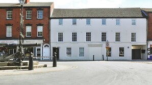 A street with a cannon, a building with multiple windows, and a sign for 'Harry's Coffee.' - Sleeps2-centrallocation-familyfriendly-newrefurb (Retford)