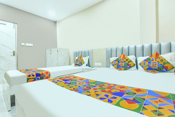 A hotel room with a bed, a nightstand, a wardrobe, and a bathroom. - FabHotel Bk International (Kolkata)