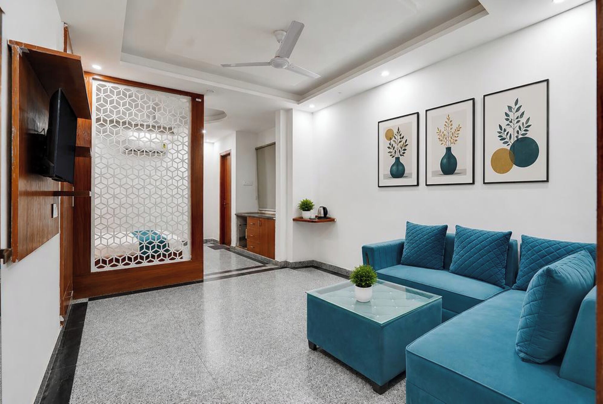 A modern living room with a sectional sofa, a coffee table, and wall art.