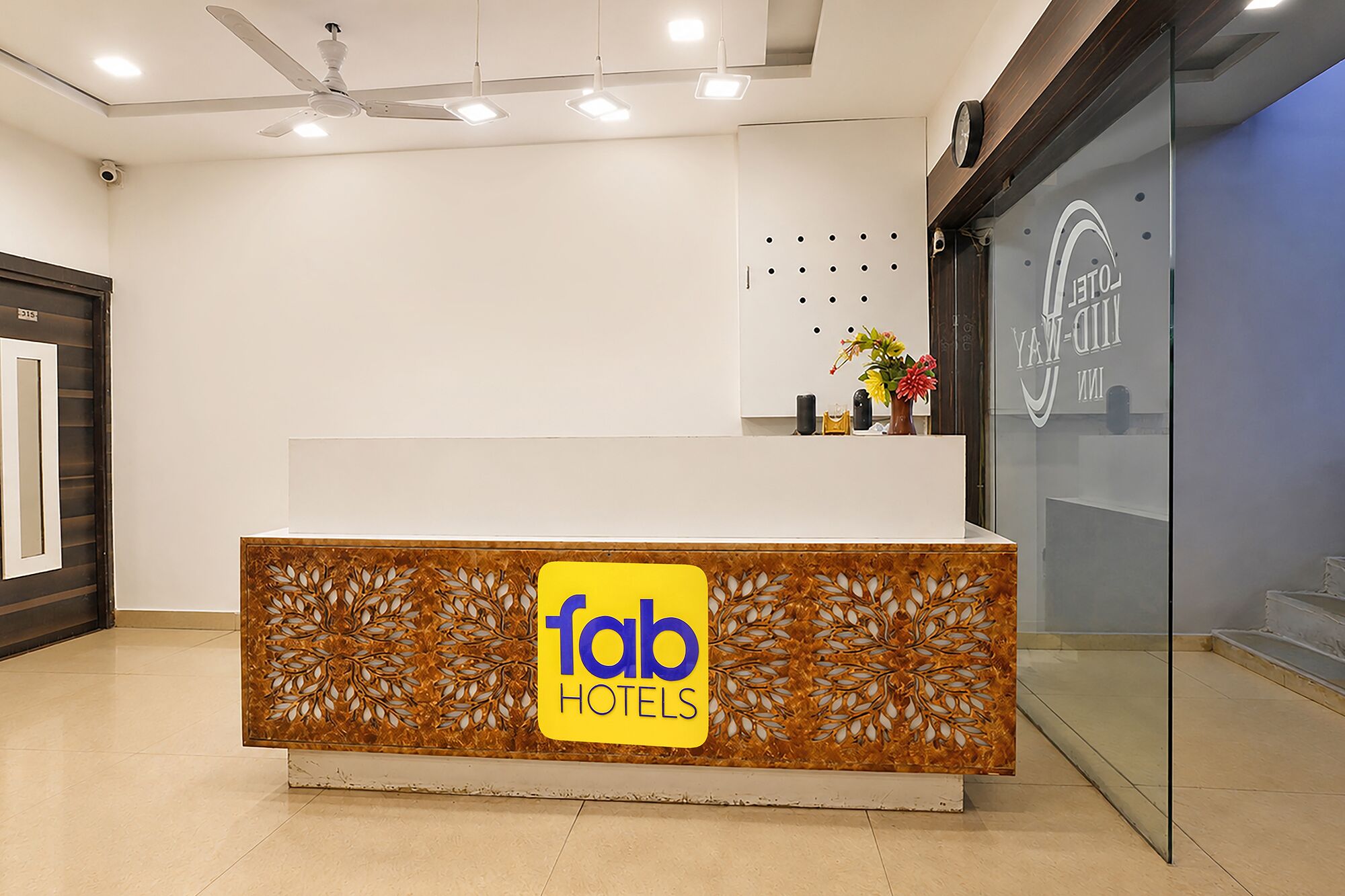 A reception desk with a logo for 'fob hotels' and a decorative panel.