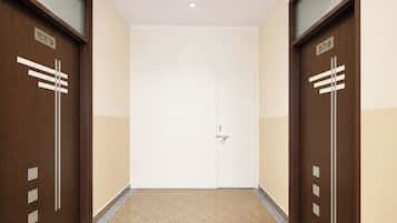 A hallway with two doors labeled '103 TO 104' and '105 TO 106' leading to a white door with a keyhole.