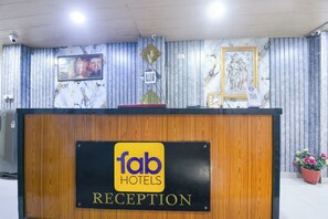 A reception desk with a sign for Fab Hotels. - FabHotel Elite 45 (New Delhi)