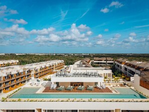 A resort with multiple buildings, a large pool area, and a clear view of the ocean. - Best Location & Views of Jaguar Park (Tulum Municipality)