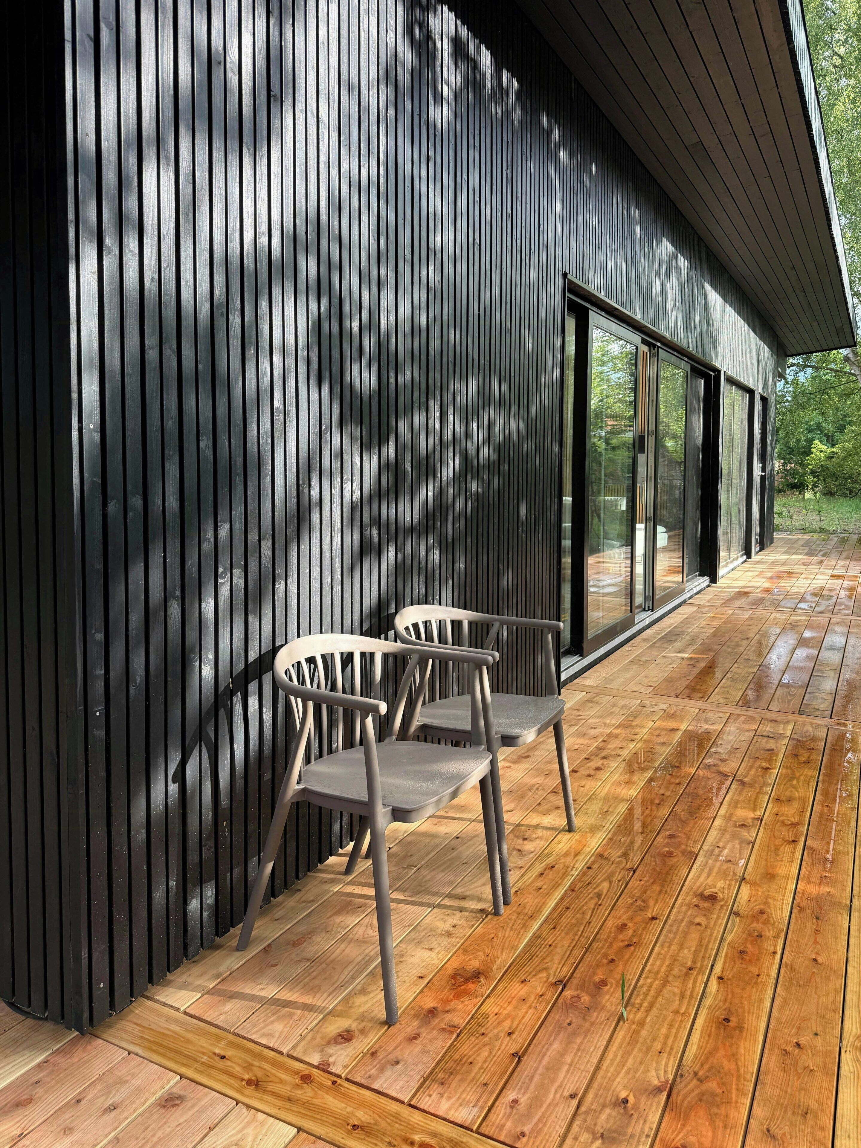 A modern building with vertical siding and large glass doors.