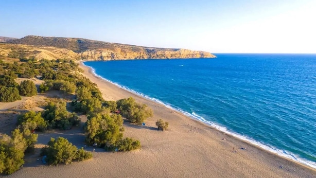 A coastal landscape with a beach, cliffs, and sparse vegetation. - Elmara Crete Beachside Villa 3 With Private Pool (Faistos)
