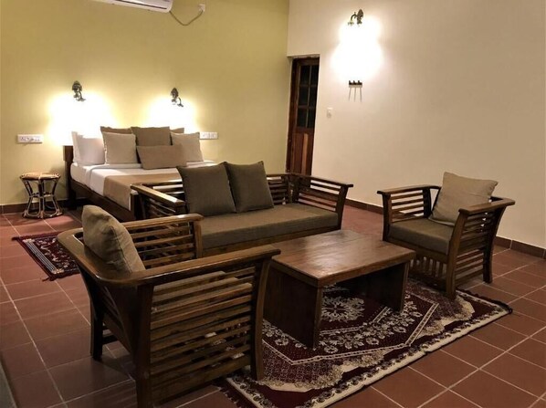 A room with a bed, wooden furniture, and wall-mounted lights.