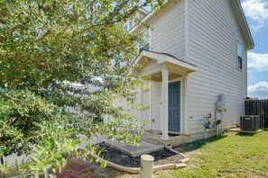 A two-story house with a covered porch, a front door, and a small garden area. - 8 Mi to Dtwn! Extended Stay in San Antonio w/ Yard (San Antonio)