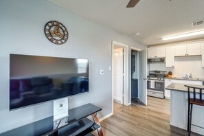 A modern kitchen with white cabinets, a stainless steel range, and a flat-screen TV mounted on the wall. - 8 Mi to Dtwn! Extended Stay in San Antonio w/ Yard (San Antonio)