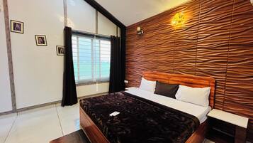 A modern bedroom with a large bed, a wooden headboard, and a window with curtains.