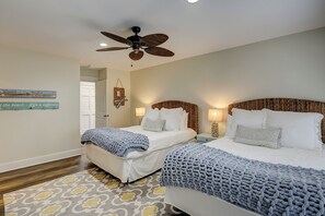 A hotel room with two beds, a ceiling fan, and a patterned rug. - 28 Ruddy Turnstone - Coastal Retreat Near the Beach with Private Pool (Hilton Head Island)