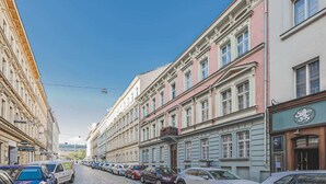 A street view with buildings, parked cars, and a clear sky. - Andel,Smichov Flat, Fresh Bath, portable AC (Praha 5)