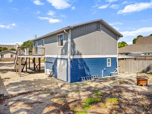 A two-story house with a deck, a satellite dish, and a fire pit in the yard. - Beach House Hideaway Near Schooners, Sand & Grand Lagoon Fun (Panama City)