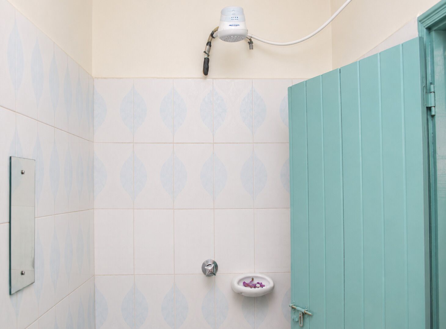 A bathroom with a shower, a toilet, and a sink.