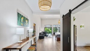 A modern interior with a wooden console table, a black rug, and a sliding door. - New Listing • Villa Emsita Hermosa • 3 BR Villa • Private Pool (Playa Hermosa)