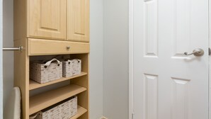 A wooden cabinet with multiple shelves, a white door, and a metal handle. - Studio w/Kitchenette, AC, WiFi, & Flat Screen - Waikīkī Grand #400 (Honolulu)
