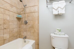A bathroom with a bathtub, shower, toilet, and towel rack. - Studio w/Kitchenette, AC, WiFi, & Flat Screen - Waikīkī Grand #400 (Honolulu)