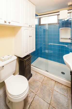 A bathroom with a toilet, a shower with a glass door, and a sink. - City View Studio w/Kitchenette - Waikīkī Grand 722 (Honolulu)