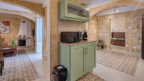 A kitchen with a green cabinet, a microwave, and a trash bin. - Beautiful 2BR home in Rabat with rooftop Terrace (Rabat)