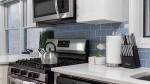 A modern kitchen with a stainless steel stove, a microwave, and a dishwasher. - Pristine Chicago Home - 3BD - 2BA - Free Parking - 2 (Chicago)