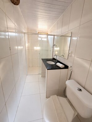 Chuveiro, toalhas de banho, sabonete, shampoo
