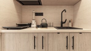 A kitchen with a countertop, a sink, a coffee maker, and a blender. - Authentic Bosnian-Herzegovinian Studio & Garden in the heart of Mostar (Mostar)