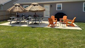A backyard with picnic tables, chairs, and a barbecue grill. - 1 Block to the Beach - 4BR - Fenced Yard - Sleeps 8 - Port Clinton - Lake Erie (Port Clinton)