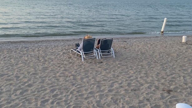 A beach with two lounge chairs and a trash bin. - 1 Block to the Beach - 4BR - Fenced Yard - Sleeps 8 - Port Clinton - Lake Erie (Port Clinton)