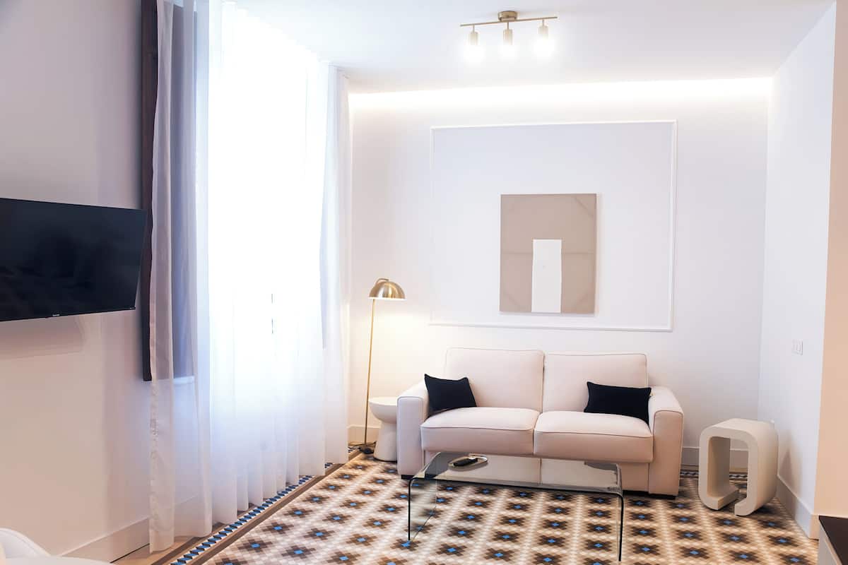 Deluxe Suite, City View | Living area | 54-inch Smart TV with digital channels, heated floors