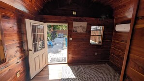 A wooden cabin interior with a door leading to an outdoor patio area. - 4BED Pool Down Town Home Near UMHB & SW Hospital (Belton)