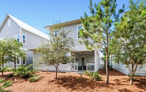 A two-story house with a porch, surrounded by pine trees and landscaped with mulch. - Pet Friendly 30A Resort Retreat Near Beach, Pool, The Big Chill, with LSV (Inlet Beach)