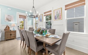 A dining area with a wooden table, chairs, and a chandelier. - Pet Friendly 30A Resort Retreat Near Beach, Pool, The Big Chill, with LSV (Inlet Beach)